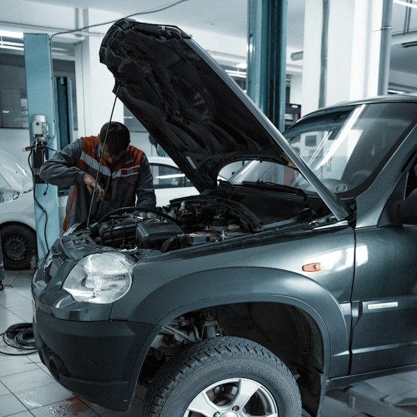Mechanic installing coilovers